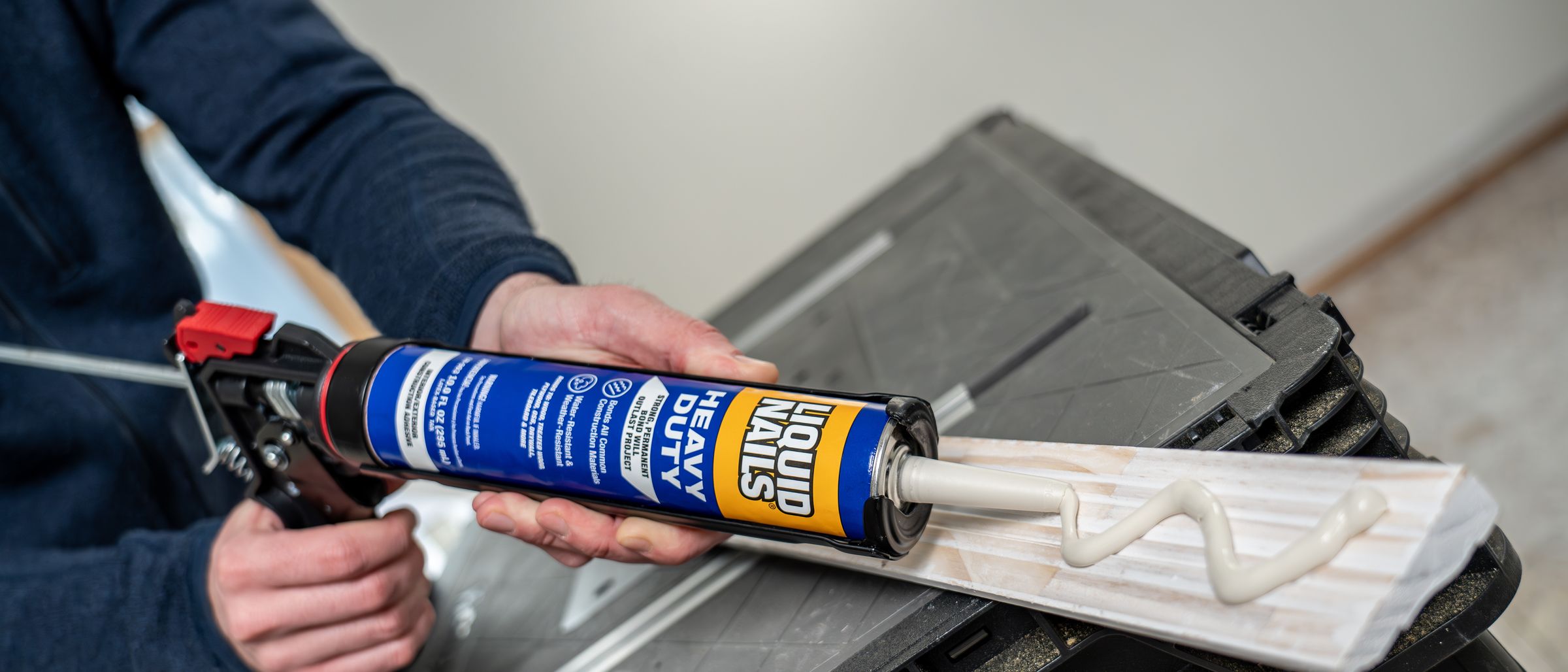 Zigzag bead of Liquid Nails Heavy Duty construction adhesive on a piece of trim